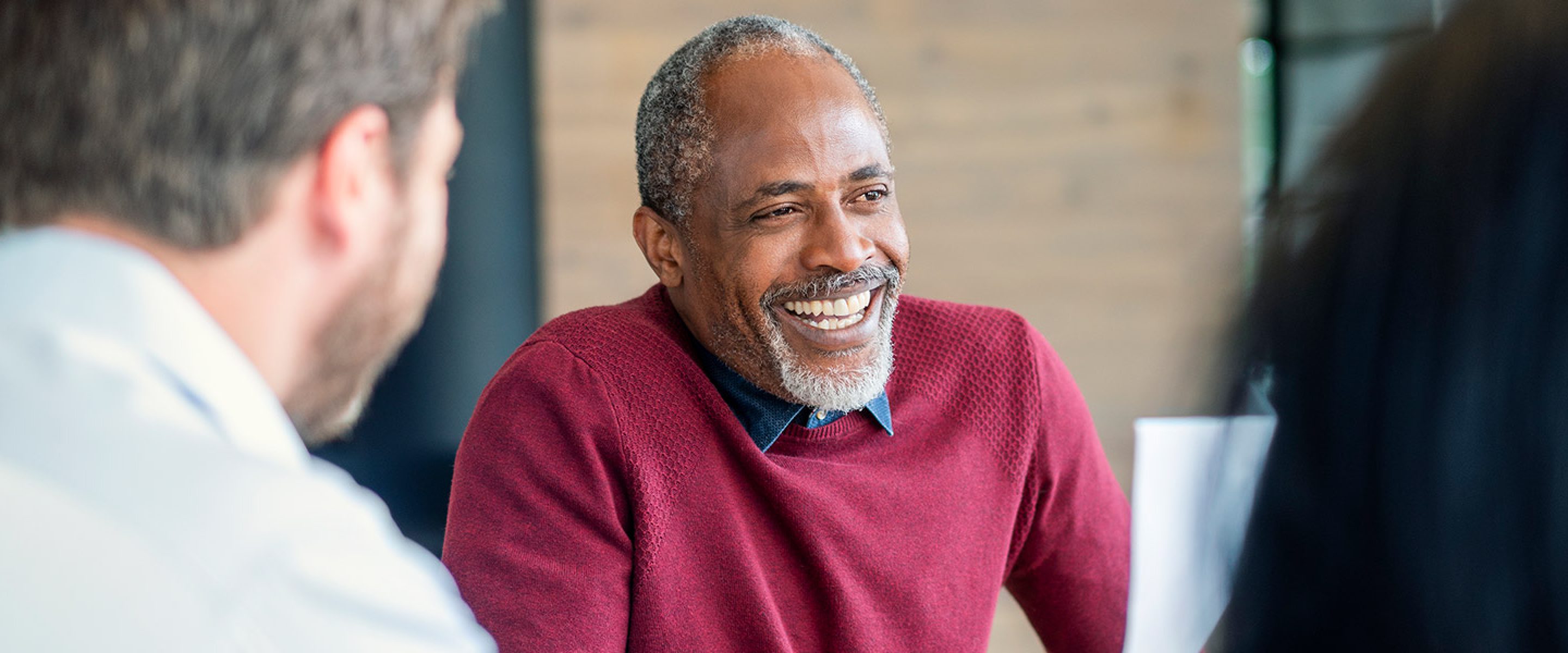 Group of business professionals smile and meet as a team