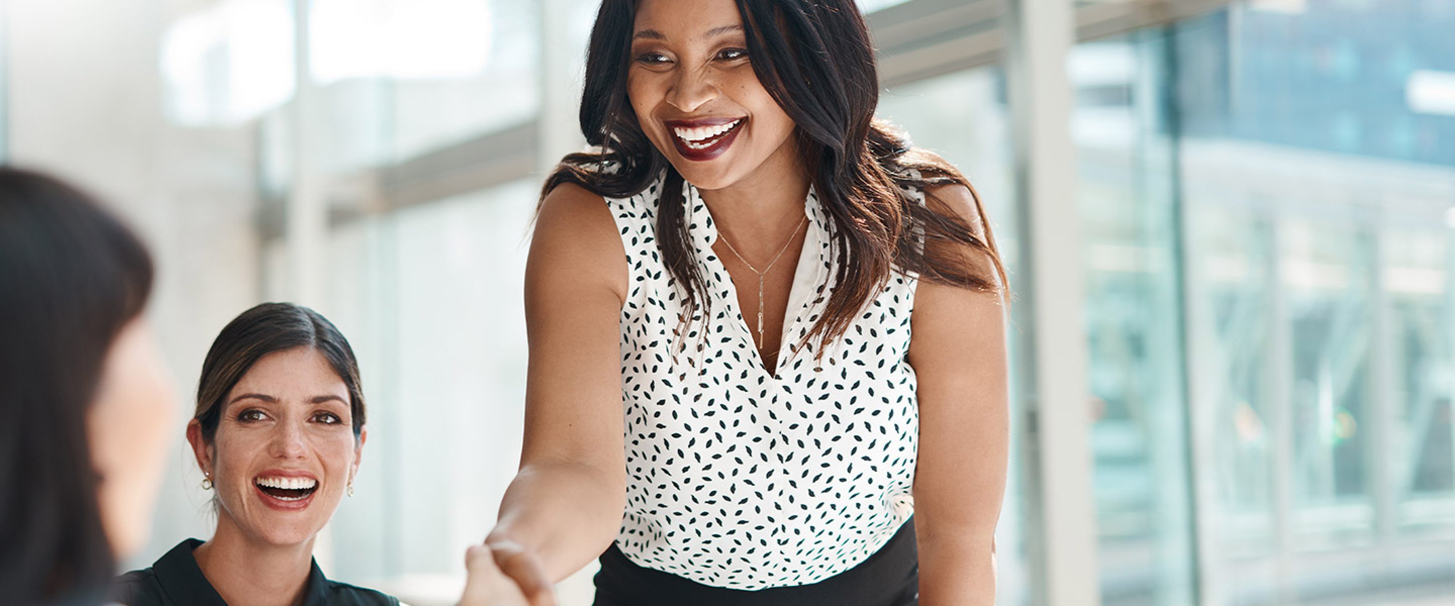 Business woman smiles and shakes hands