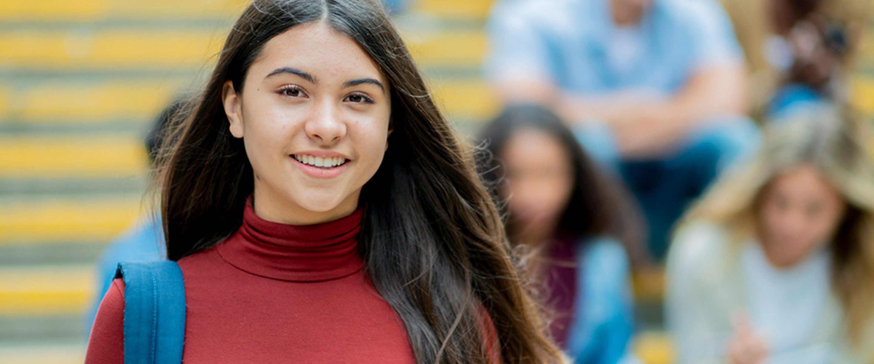 Female student with backpack smiling