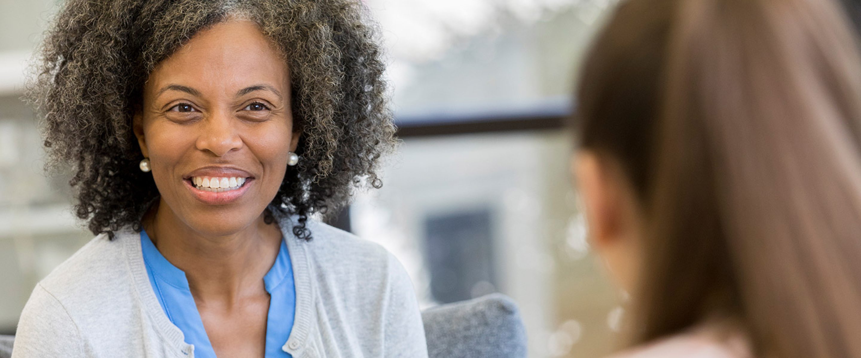African American educator meets with young female student