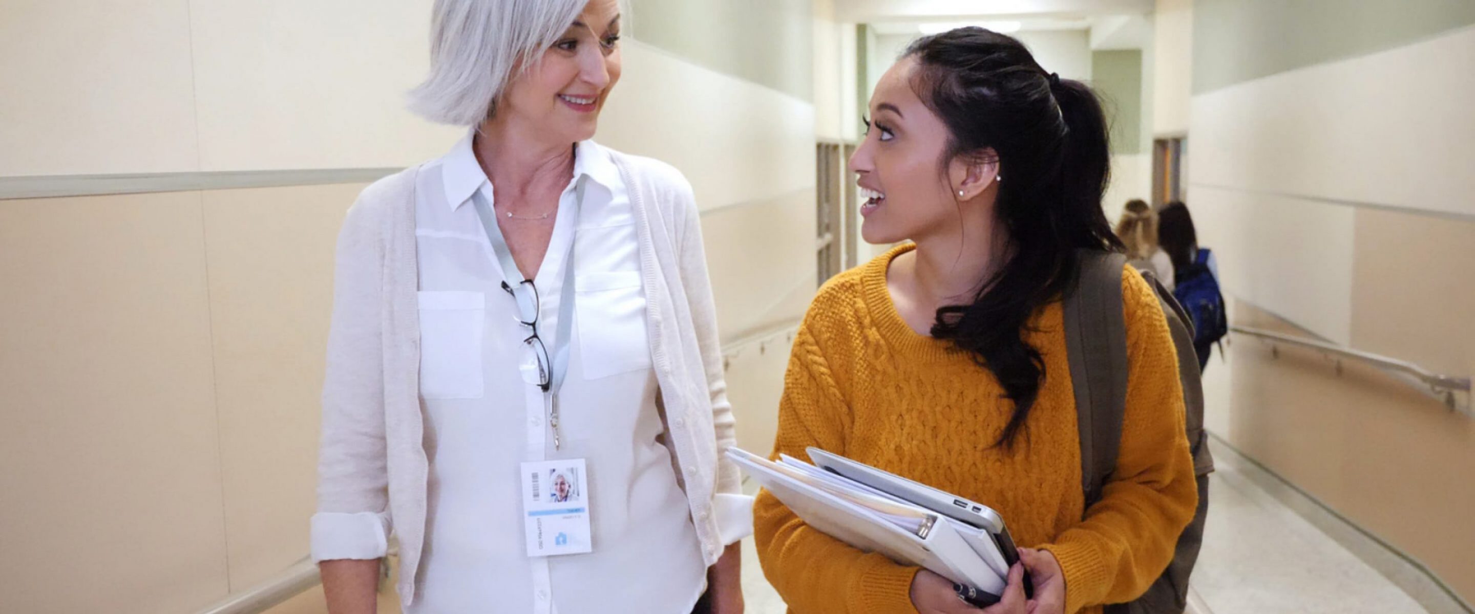 Doctor and student walk down hallway